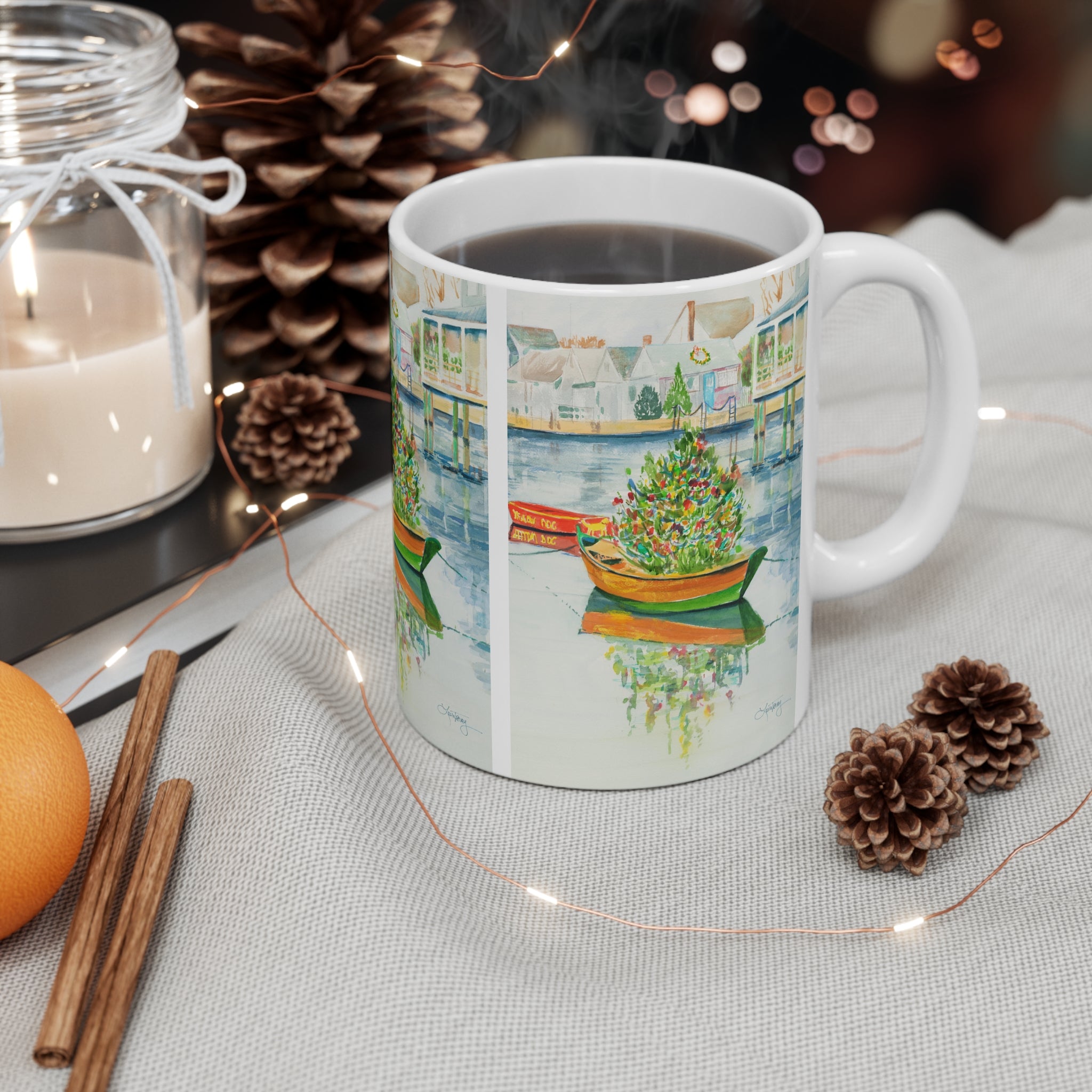 Christmas on Nantucket Mug by Laura Trevey, mug filled with coffee on a holiday table with a candle, pinecones, and cinnamon sticks