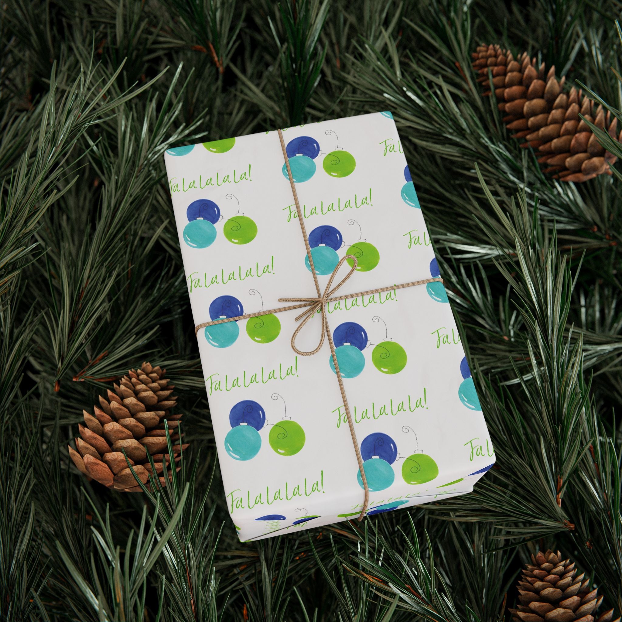 Fa La La La La! Wrapping Paper | Blue & Lime Watercolor Christmas Gift Wrap – wrapped gift tied with twine on evergreen branches with pinecones