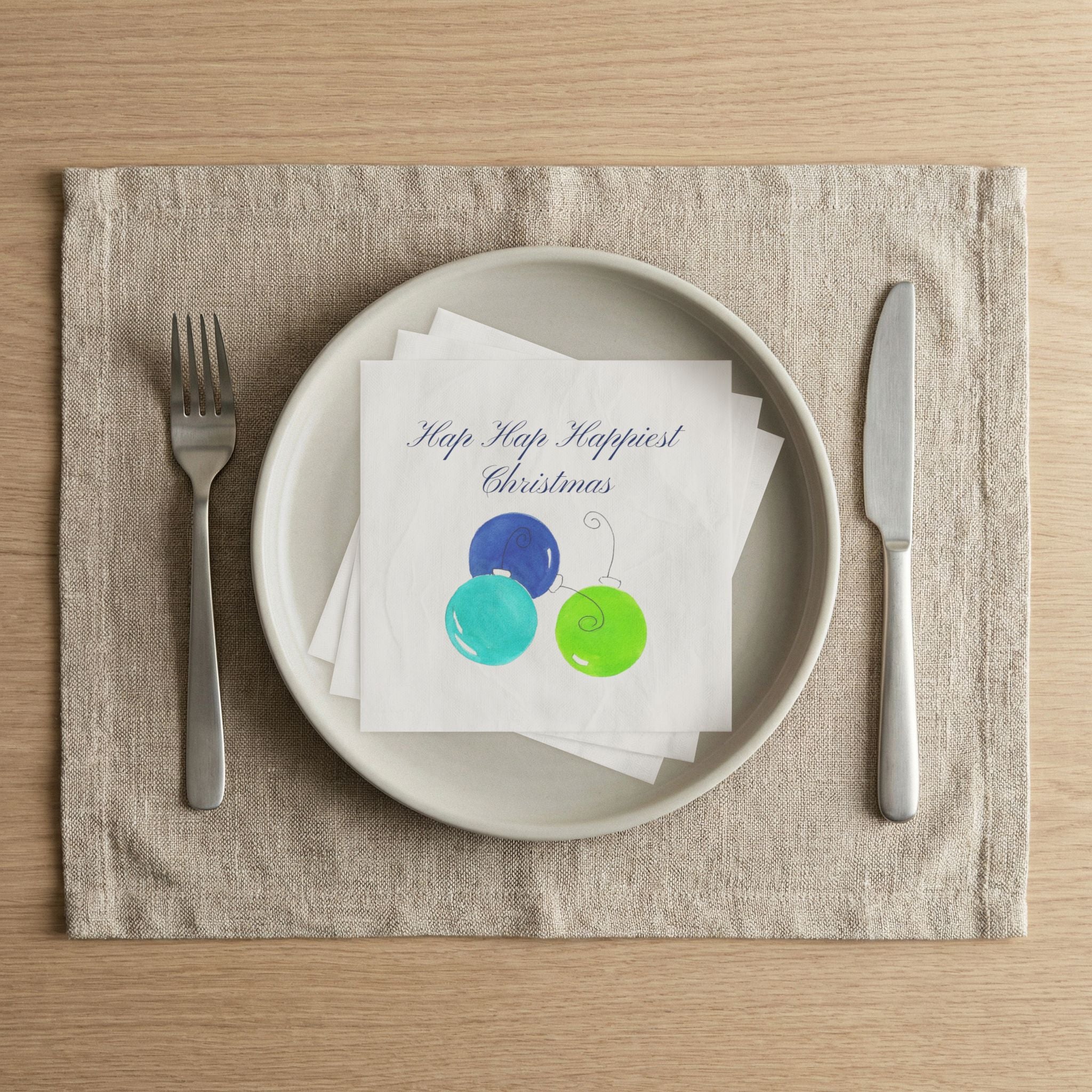 Hap Hap Happiest Christmas blue ornament napkin on a dinner plate for a holiday party