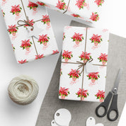 Poinsettia wrapping paper with red watercolor poinsettias on white by Laura Trevey, gifts wrapped with string and gift tags