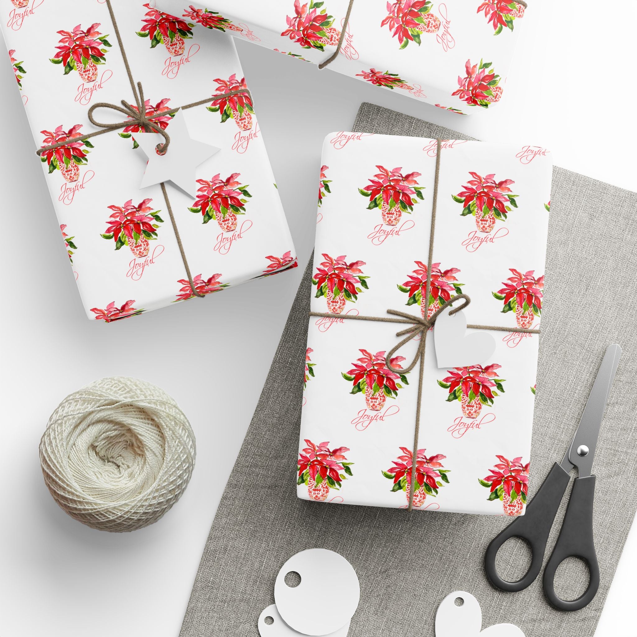 Poinsettia wrapping paper with red watercolor poinsettias on white by Laura Trevey, gifts wrapped with string and gift tags