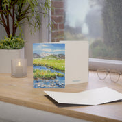Grand Teton watercolor greeting card, standing on a windowsill desk with envelope