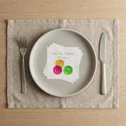 Hap Hap Happiest Christmas cocktail napkins on a linen placemat place setting