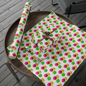 Watercolor Christmas Ornament Wrapping Paper | Pink & Lime Holiday Gift Wrap Roll – roll and wrapped gift with a gold ribbon bow on a round wooden tray