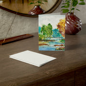A River Runs Through It watercolor greeting card, on a wooden dresser with envelope