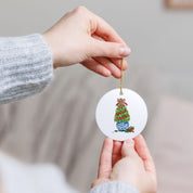 Boxwood Christmas topiary personalized ornament held up as a holiday gift