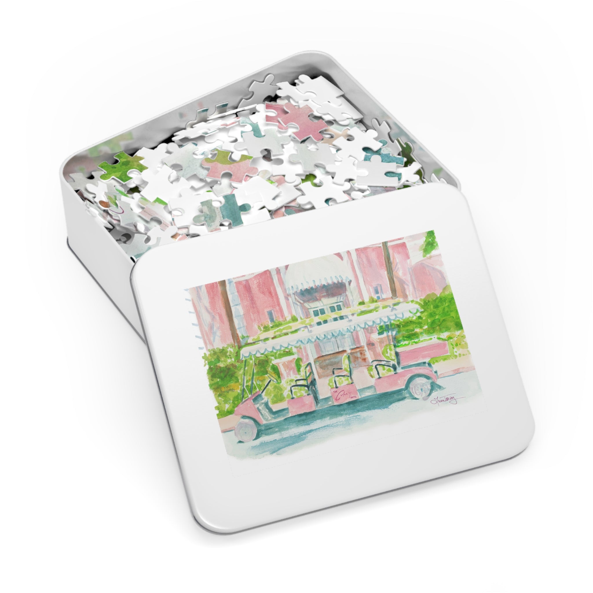 The Colony Hotel Jigsaw Puzzle by Laura Trevey, white metal puzzle gift tin with watercolor lid
