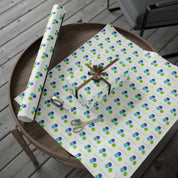 Fa La La La La! Wrapping Paper | Blue & Lime Watercolor Christmas Gift Wrap – roll and wrapped gift with a brown ribbon bow on a round wooden tray
