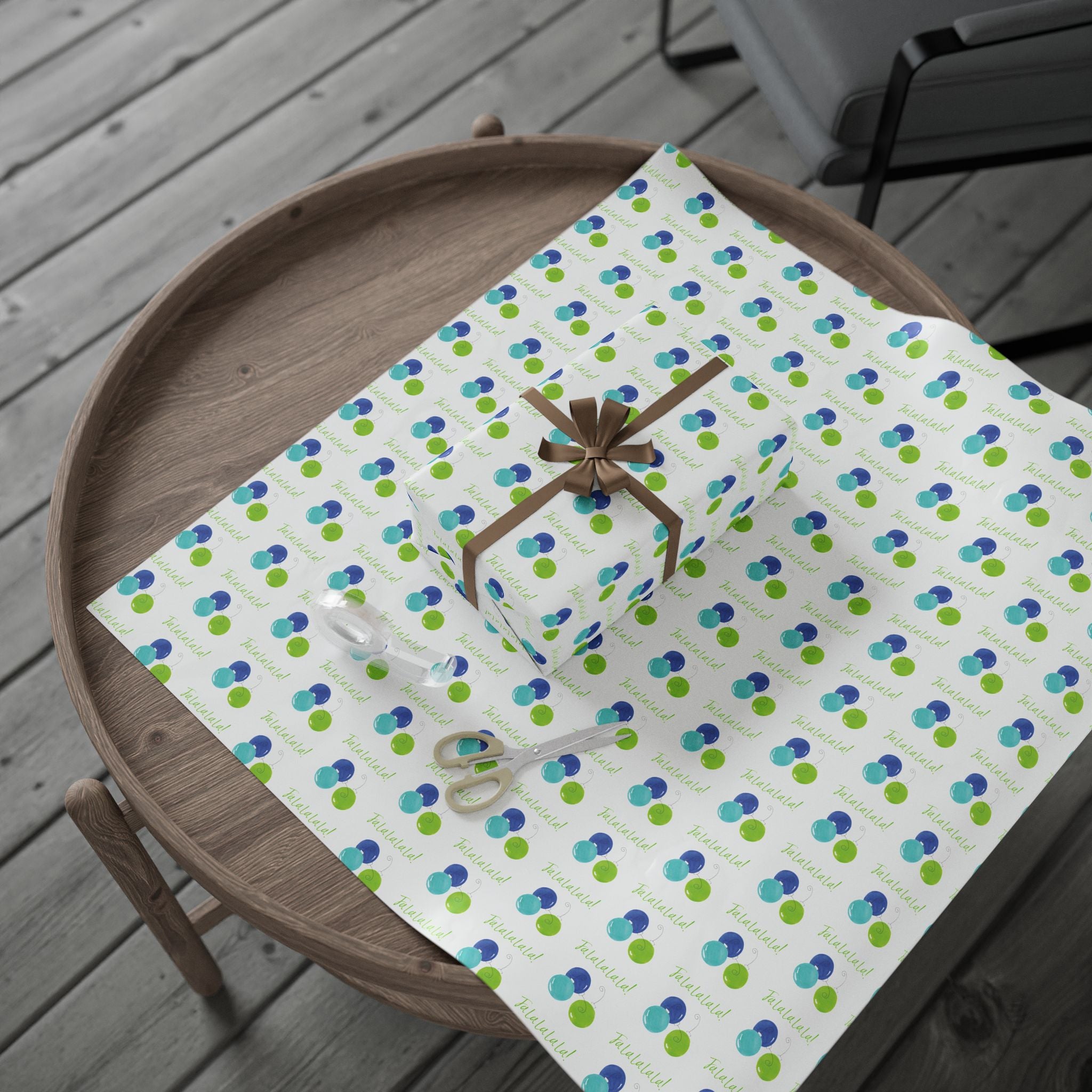 Fa La La La La! Wrapping Paper | Blue & Lime Watercolor Christmas Gift Wrap – full sheet with a wrapped gift and brown ribbon bow on a round wooden tray