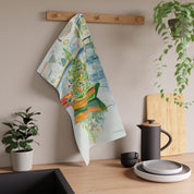 Christmas on Nantucket Tea Towel by Laura Trevey, tea towel hanging from a wooden peg rail in a kitchen