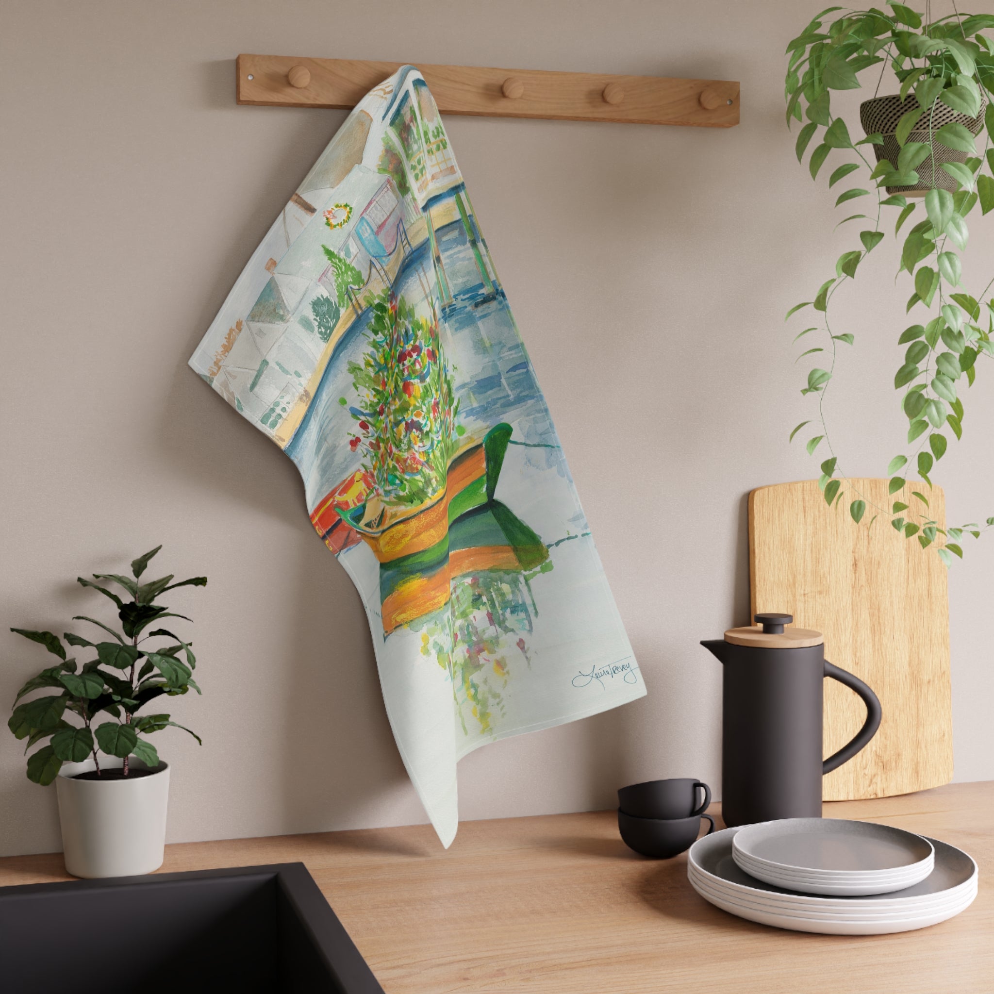 Christmas on Nantucket Tea Towel by Laura Trevey, tea towel hanging from a wooden peg rail in a kitchen
