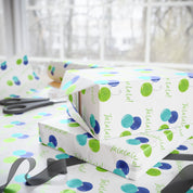 Fa La La La La! Wrapping Paper | Blue & Lime Watercolor Christmas Gift Wrap – stacked gifts and gift wrap with black ribbon in a bright holiday wrapping scene