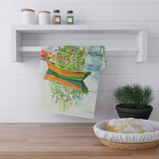 Christmas on Nantucket Tea Towel by Laura Trevey, tea towel hanging from a white kitchen shelf above a bread basket