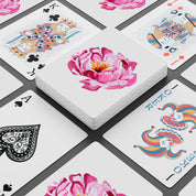 Playing cards with floral and decorative designs on a white background
