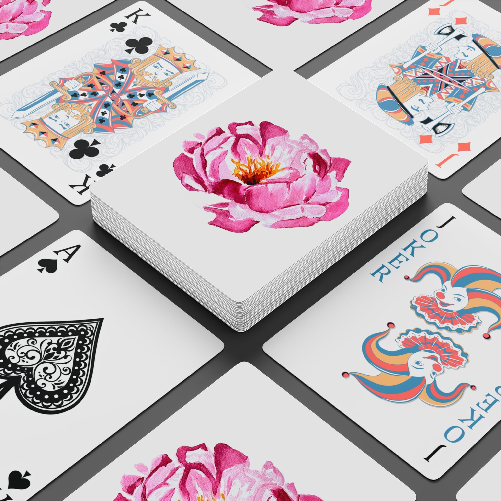 Playing cards with floral and decorative designs on a white background