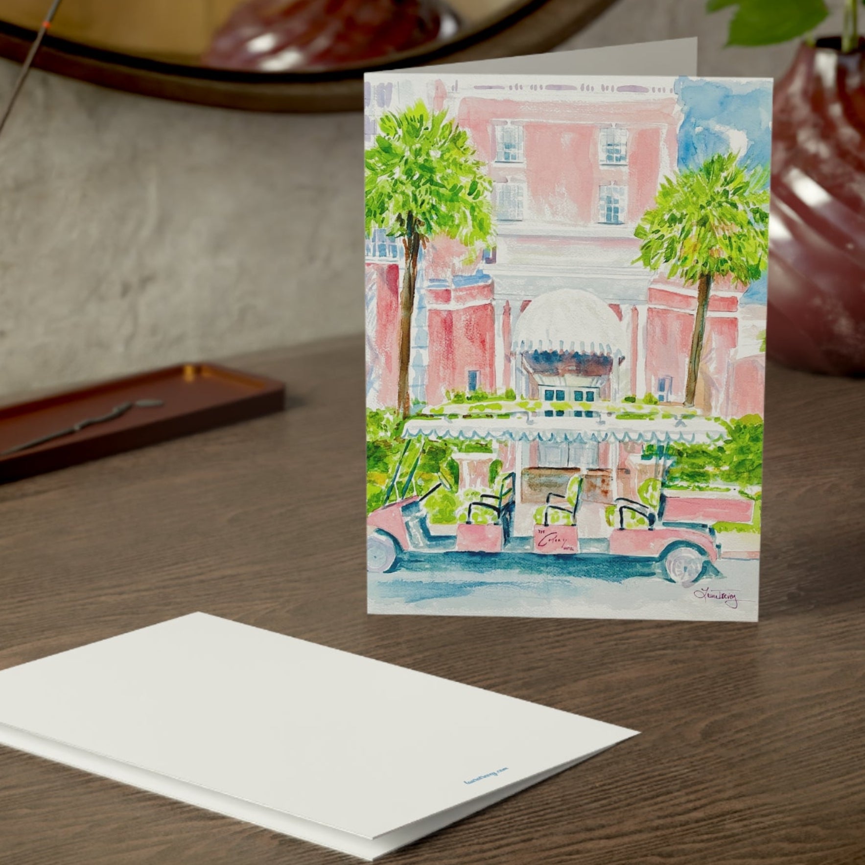 The Colony Hotel watercolor greeting card, on a wooden dresser with envelope