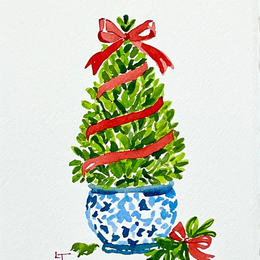 5x7 original watercolor of a boxwood Christmas topiary with a red ribbon and bow in a blue and white chinoiserie planter by Laura Trevey