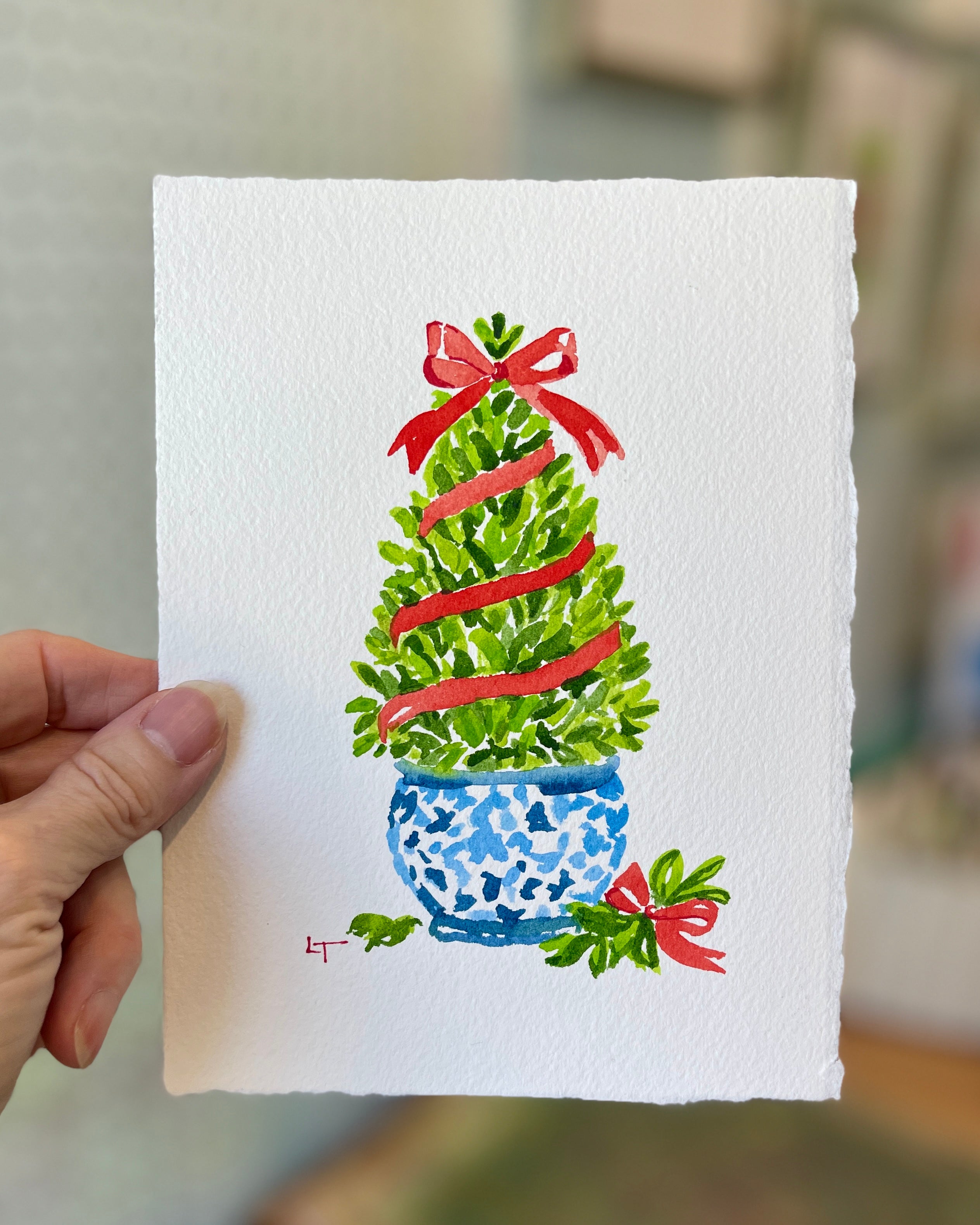 5x7 boxwood Christmas topiary watercolor held in hand for scale