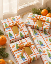 Citrus orange tree Christmas wrapping paper on gifts with orange ribbon and fresh oranges