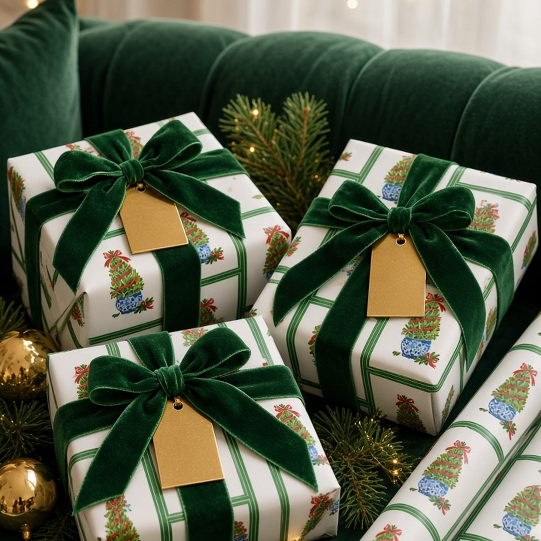 Emerald boxwood topiary Christmas wrapping paper on gifts with green velvet ribbon and gold tags