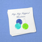 Hap Hap Happiest Christmas Blue Cocktail Napkins | Watercolor Ornament Paper Napkins – stack of cocktail napkins on periwinkle blue linen