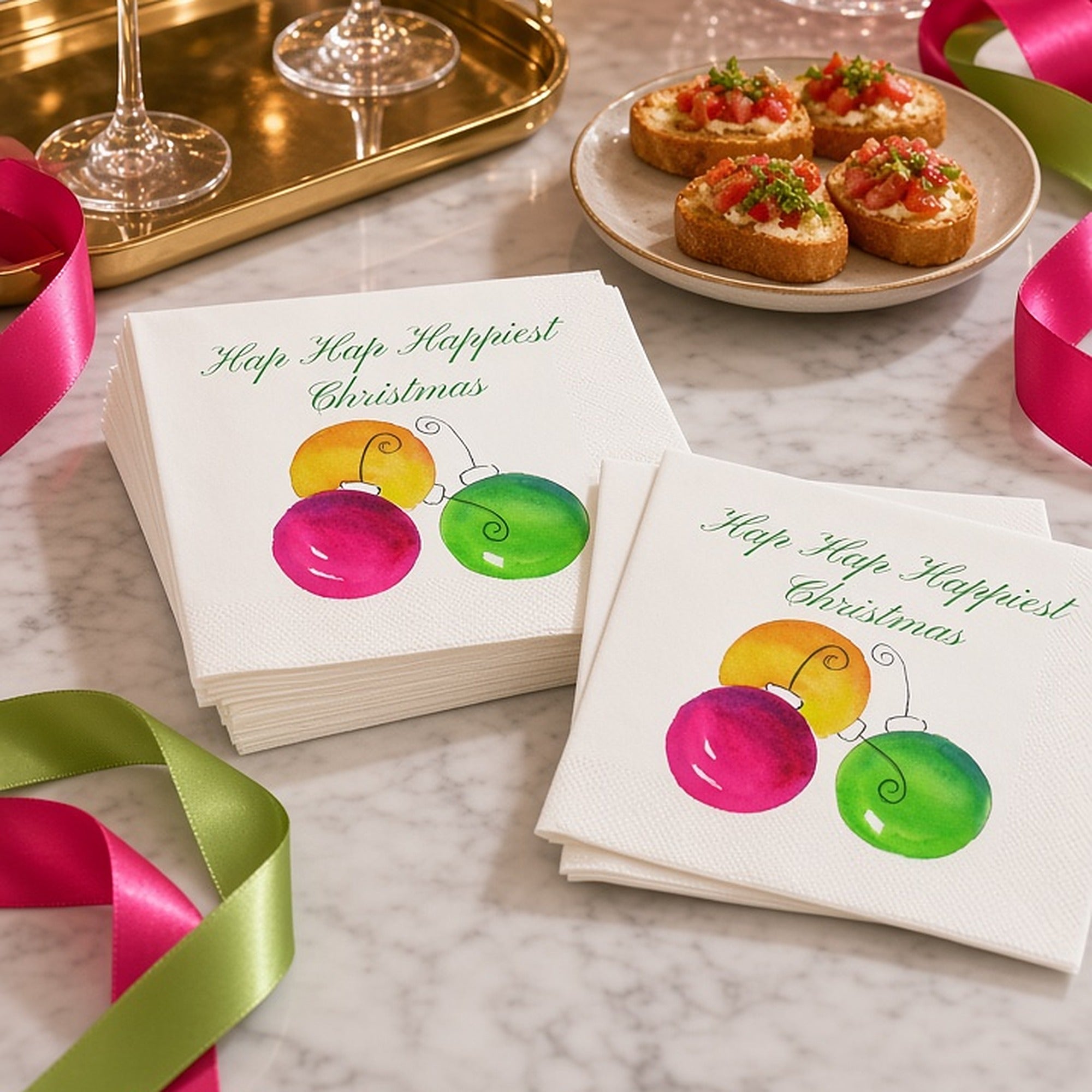 Hap Hap Happiest Christmas Cocktail Napkins | Watercolor Ornament Paper Napkins – Hap Hap Happiest Christmas cocktail napkins by Laura Trevey with pink, orange and lime watercolor ornaments on white marble with pink martinis and a bowl of ornaments
