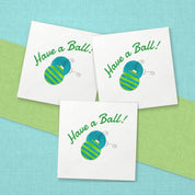 Have a Ball Christmas Cocktail Napkins | Watercolor Ornament Paper Napkins – paper napkins spread on aqua linen with a lime green table runner