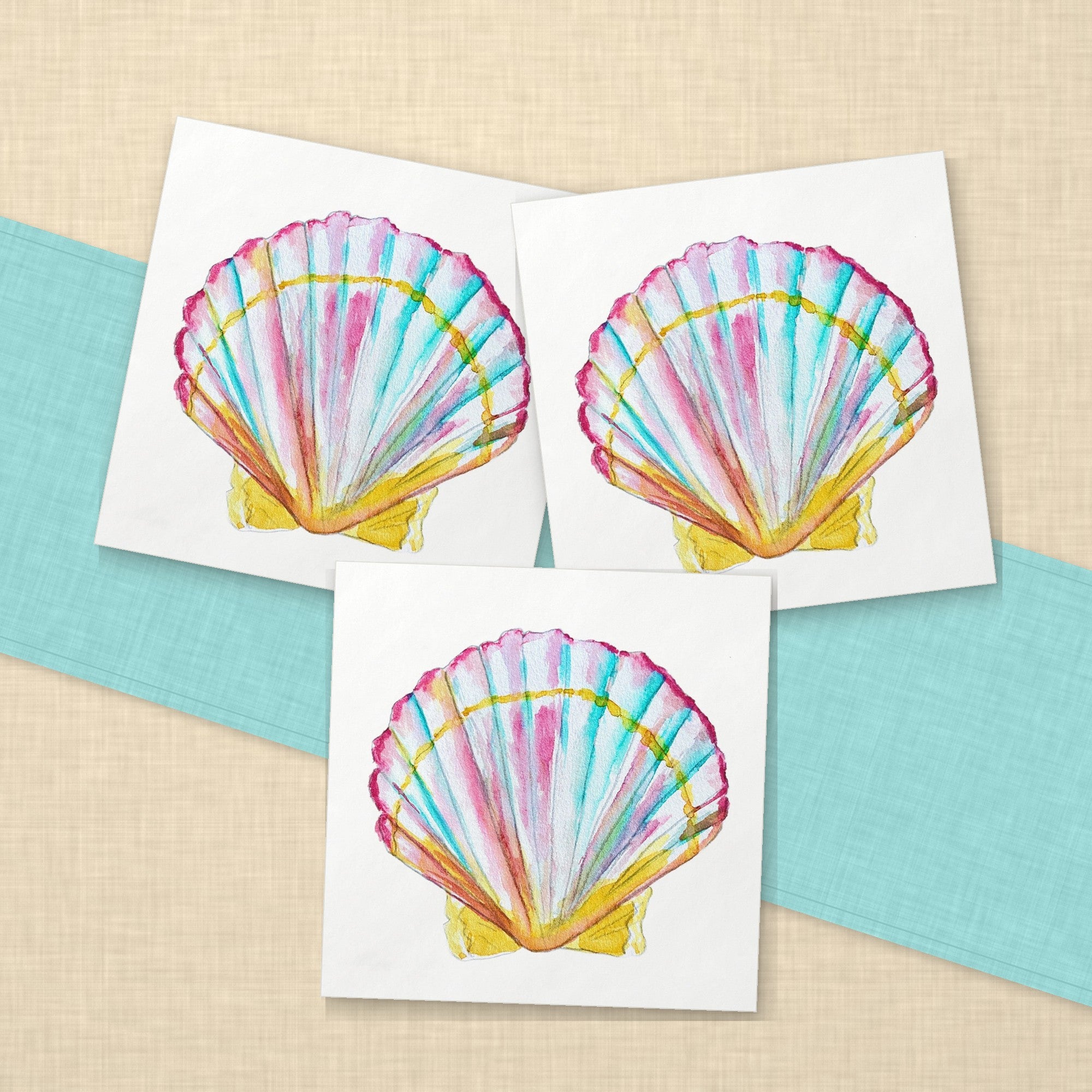 Scallop Shell Cocktail Napkins | Coastal Watercolor Paper Napkins – paper napkins spread on sand linen with an aqua table runner