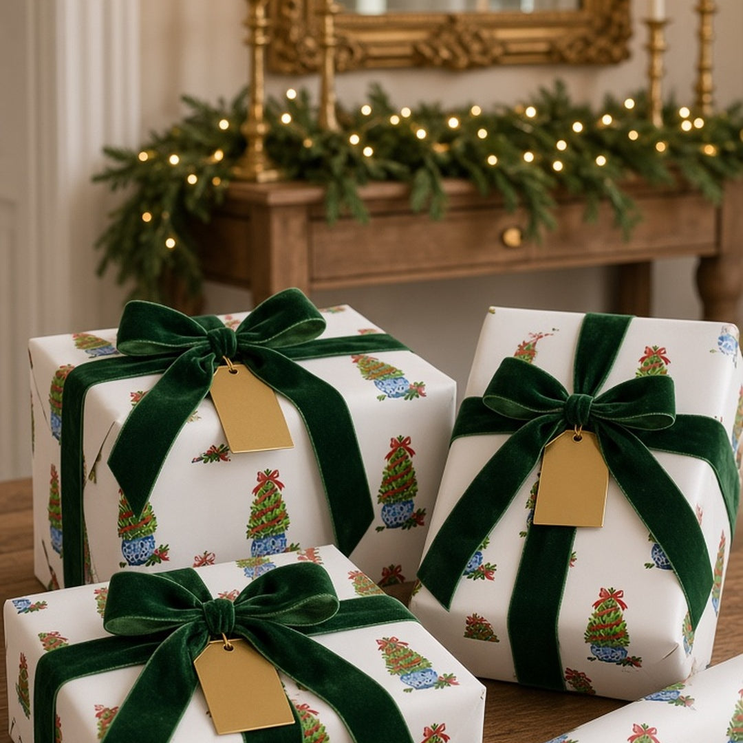 Boxwood topiary Christmas wrapping paper on gifts with green velvet ribbon and gold tags