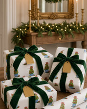 Boxwood topiary Christmas wrapping paper on gifts with green velvet ribbon and gold tags